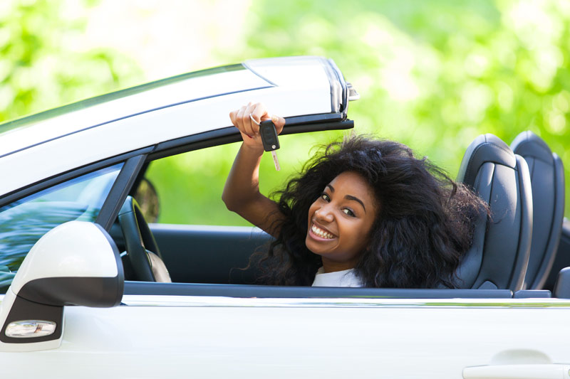 Happy woman financing her new car